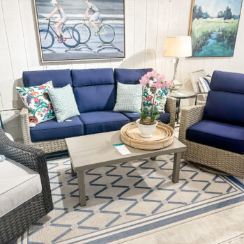 Grand Stafford by NCI wicker sofa and chair with bright blue cushions and colorful accent pillows